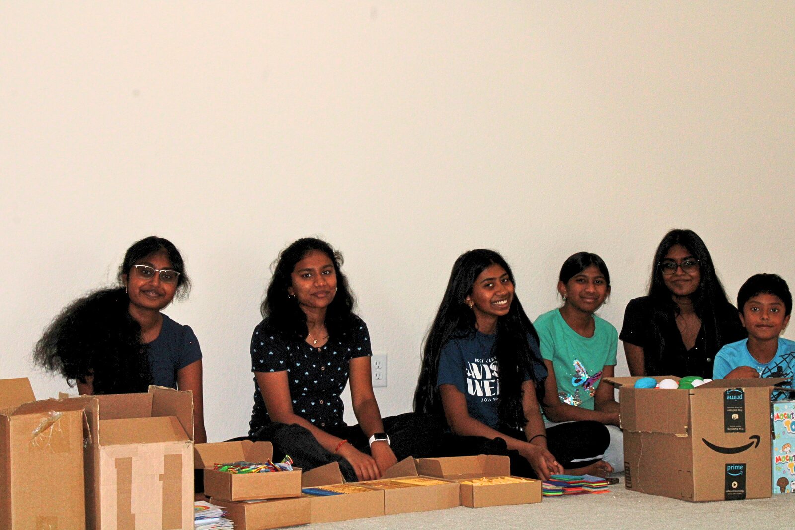 Volunteers sitting together working on kit materials