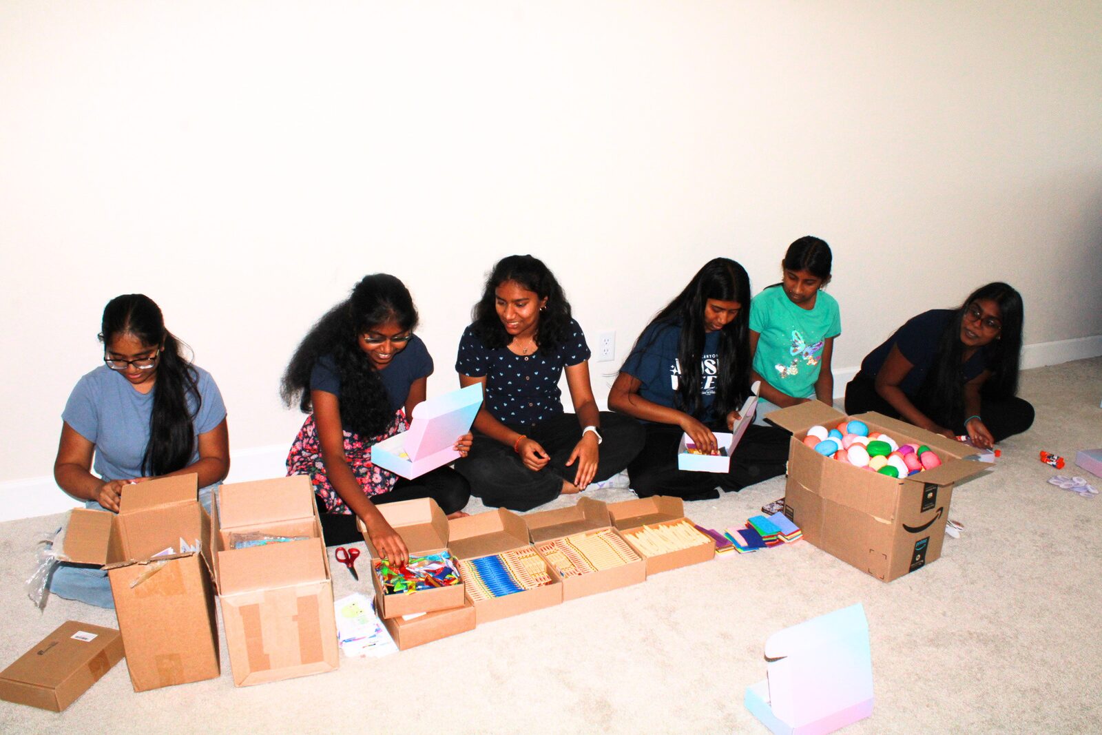 Volunteers laughing together while packing kits