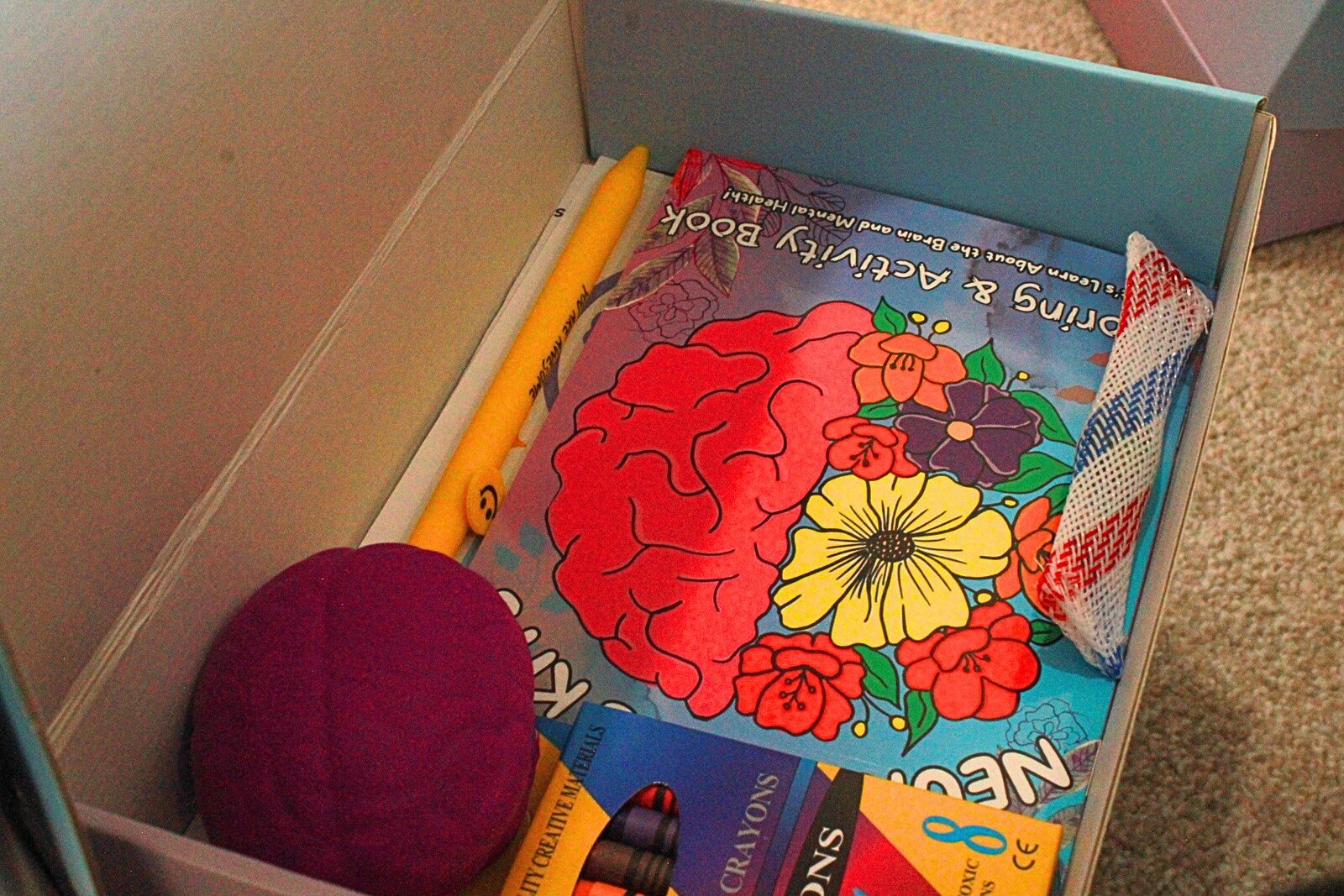 Supplies including pencils, ribbons, and stress toys ready for packing