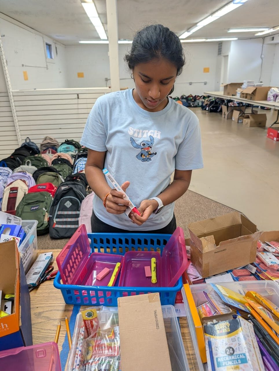 Volunteer labeling school supplies