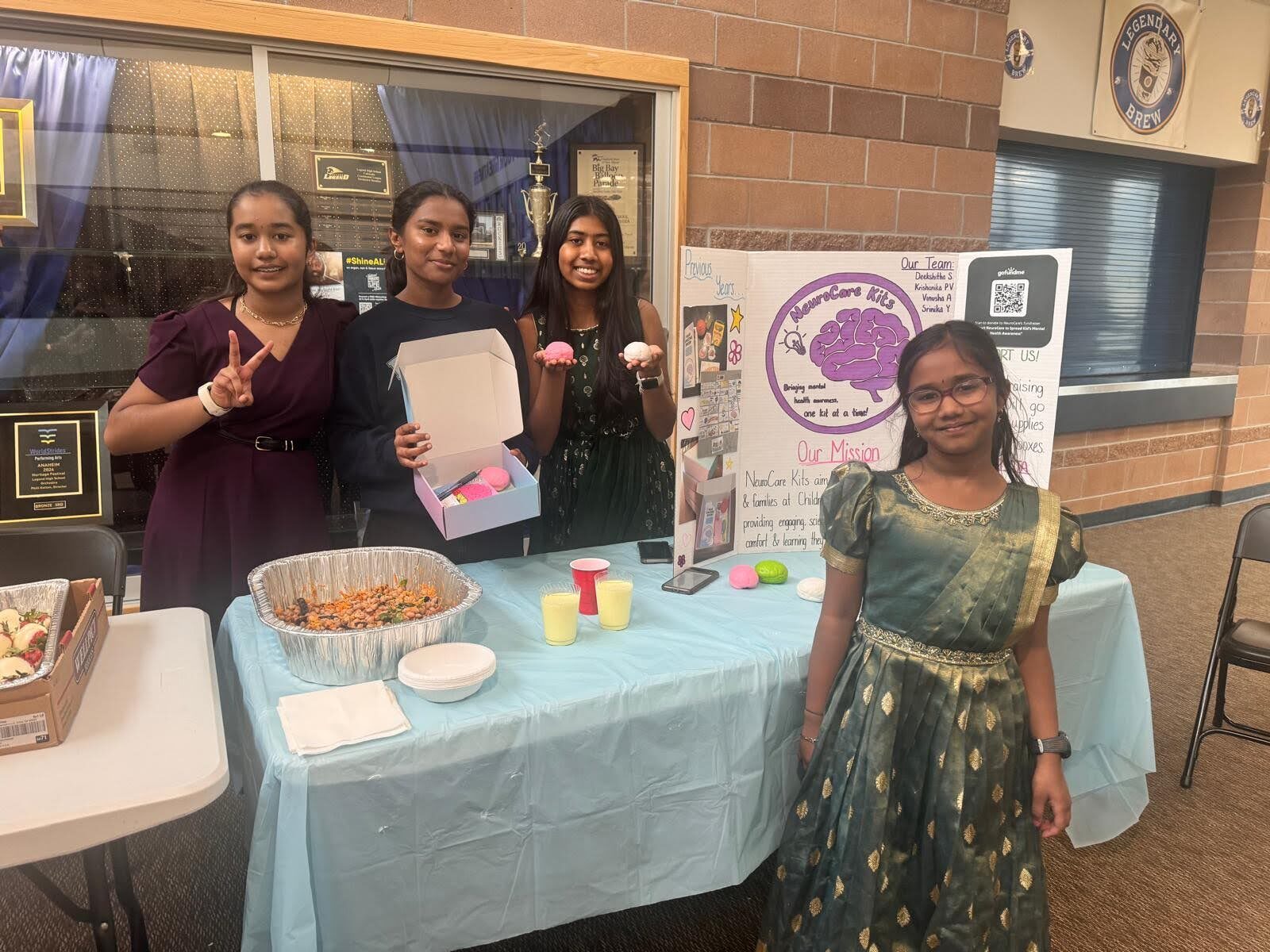 Team members with their fundraiser table and stress ball treats