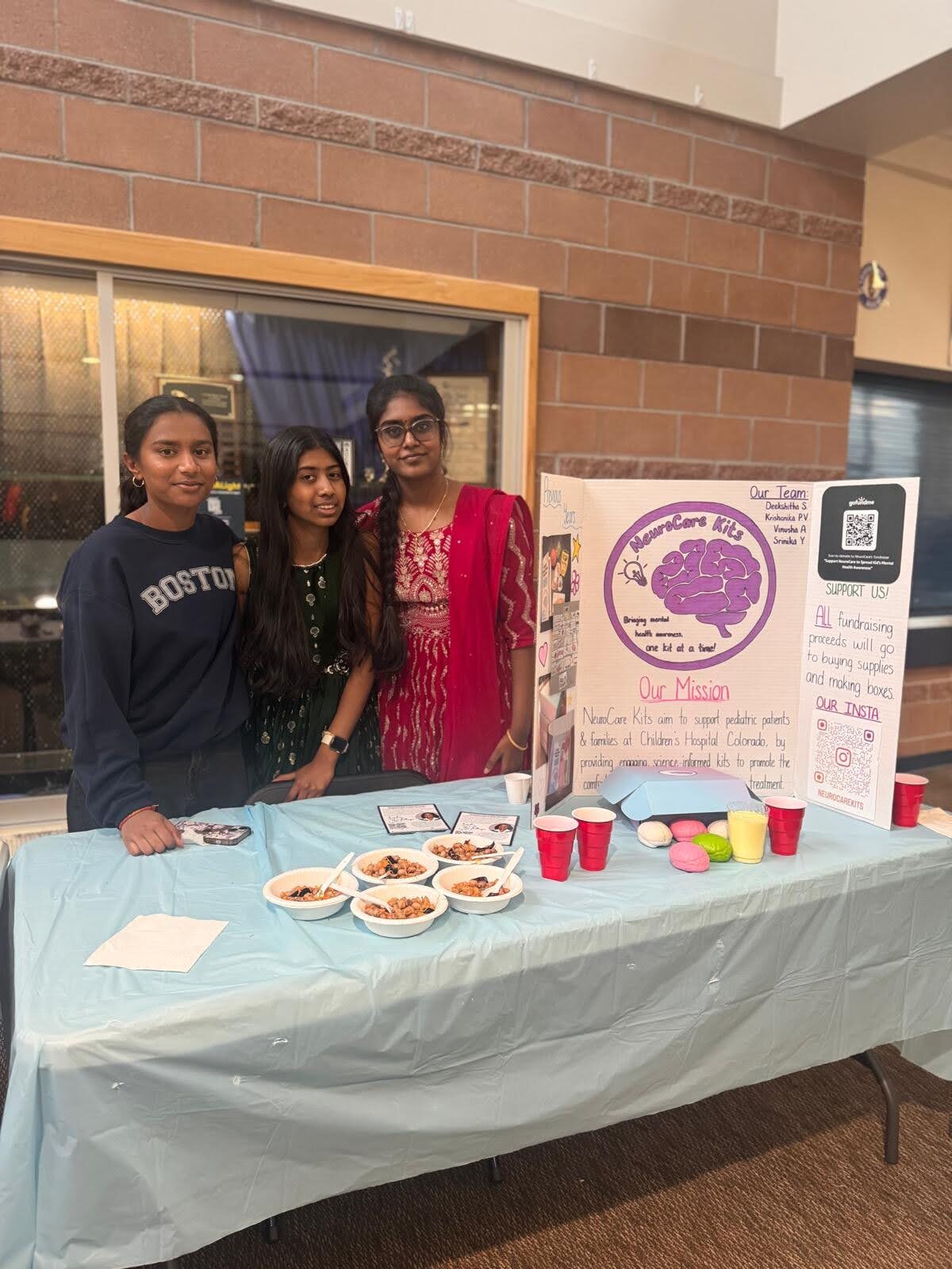 Volunteers selling snacks at the fundraiser table