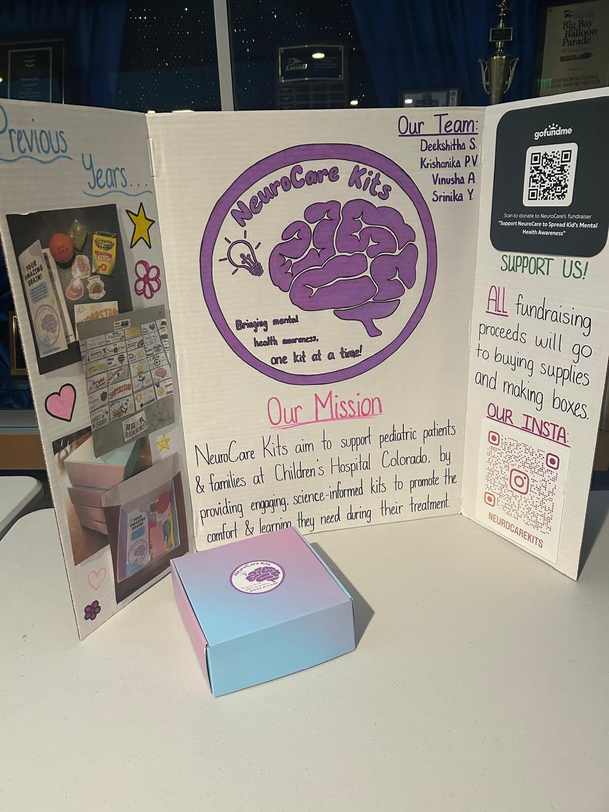 NeuroCare Kits tri-fold display board with mission statement