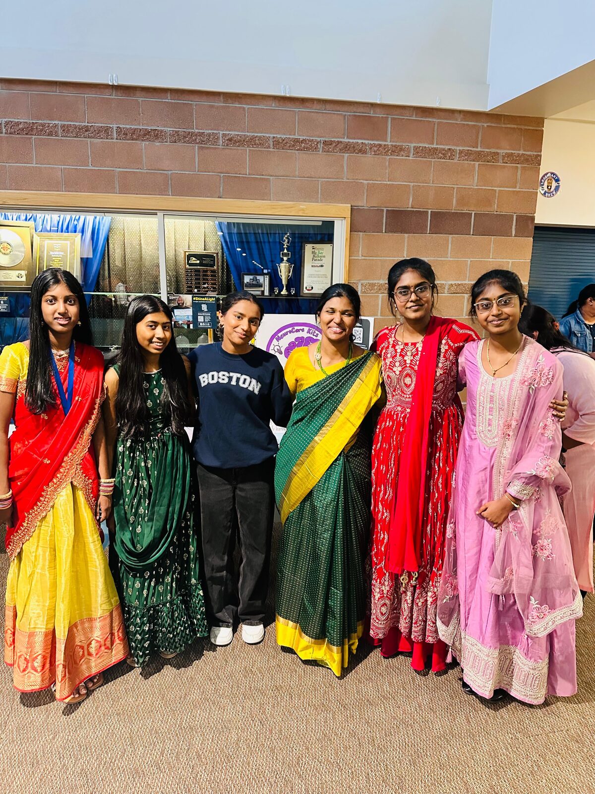 Team members in traditional attire at the Tamil Association event
