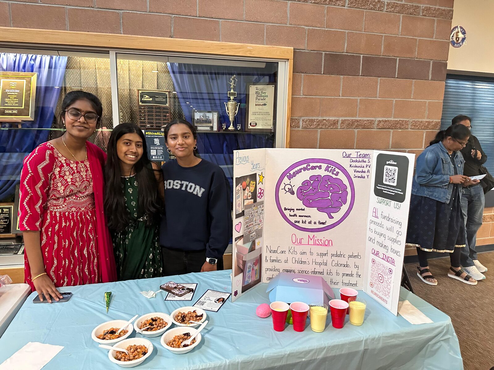 Volunteers at the fundraiser table with snack bowls