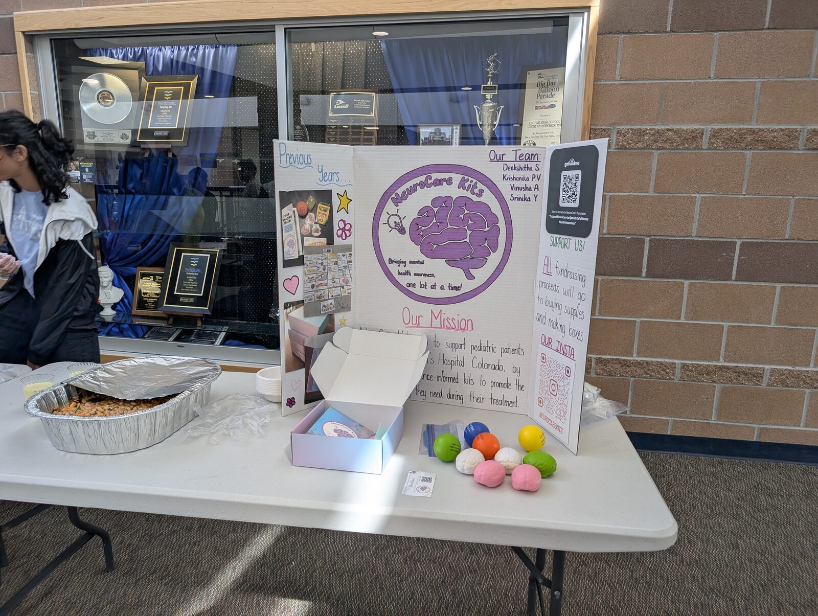 Fundraiser table with stress balls and snacks on display