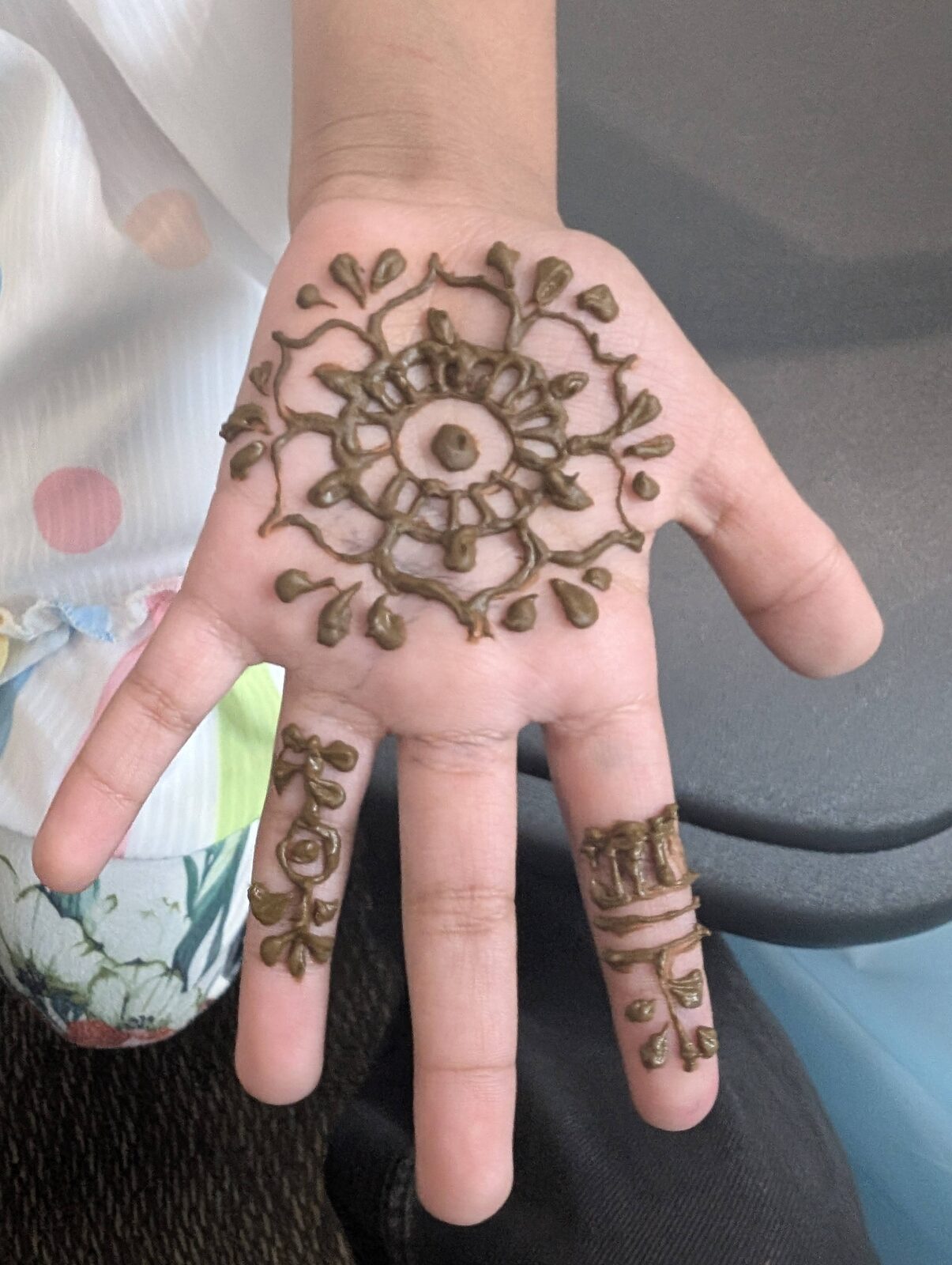 Henna design on a young supporter's hand